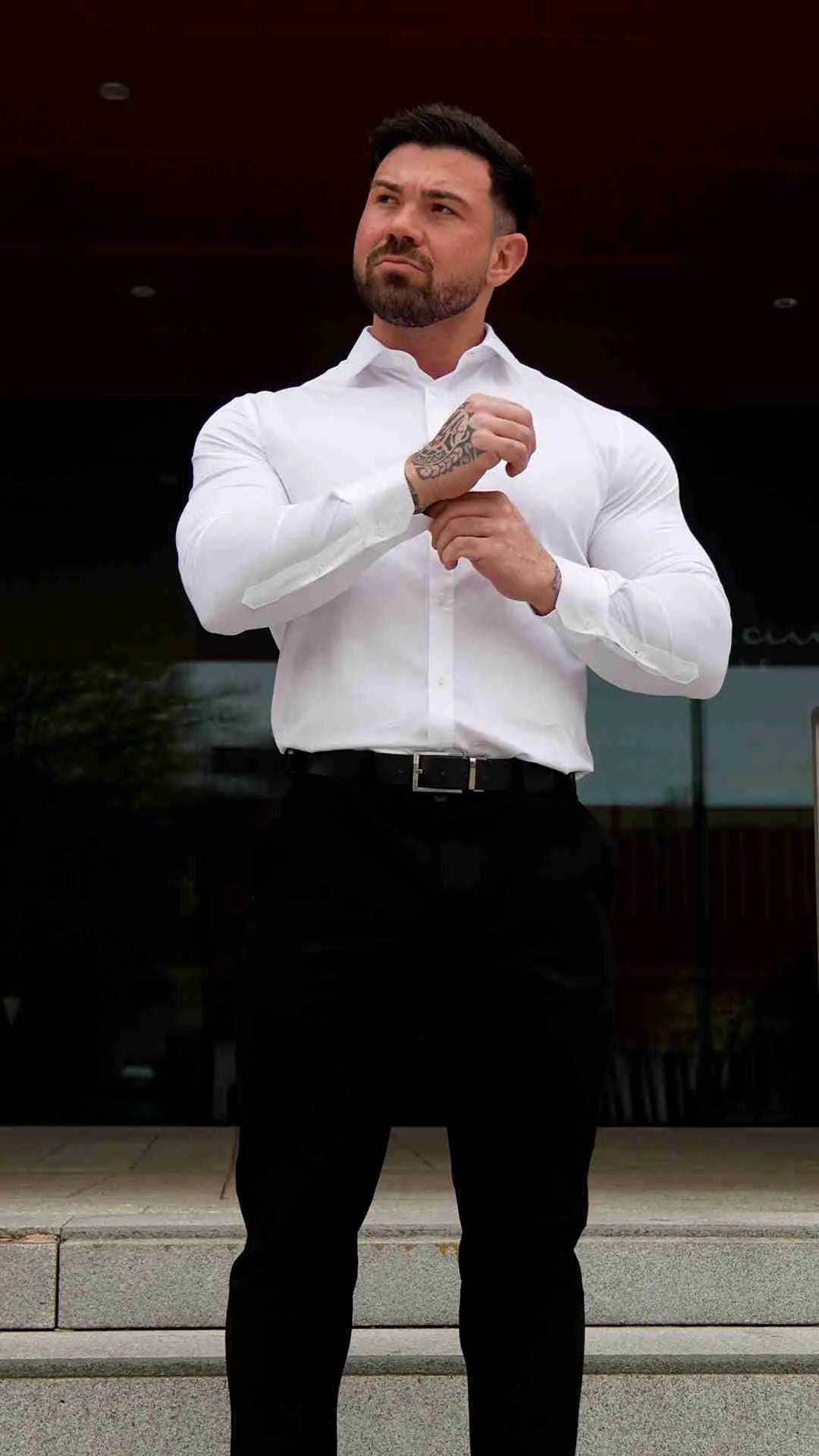 Men is wearing a white muscle-fit shirt.